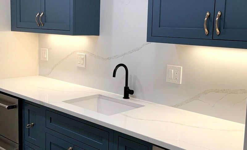 Task lighting above sink and cabinets in Boston basement kitchen remodel by Honorato Company