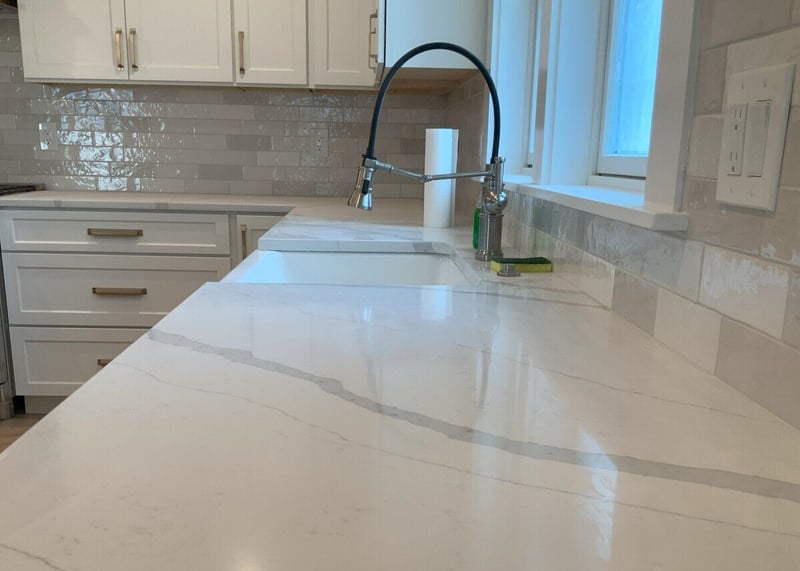 Kitchen sink with white countertops in Boston kitchen remodel by Honorato Company